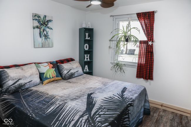 bedroom featuring ceiling fan, baseboards, and wood finished floors | Image 5