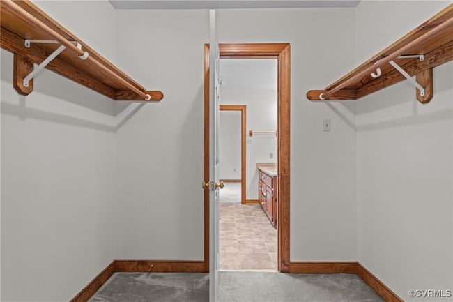 Spacious closet featuring light colored carpet | Image 20