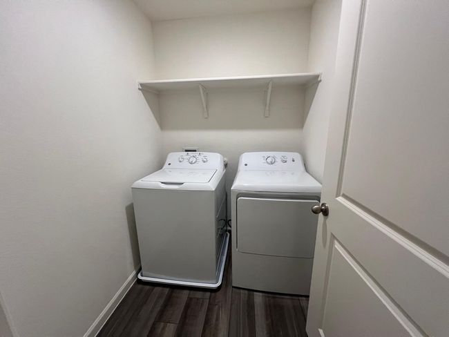 Laundry area featuring washer and dryer, dark wood-type flooring, and baseboards | Image 25