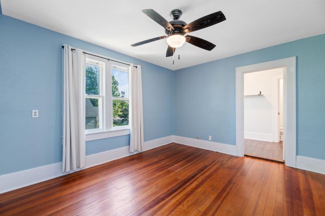 Unfurnished room with hardwood / wood-style flooring, baseboards, and ceiling fan | Image 29