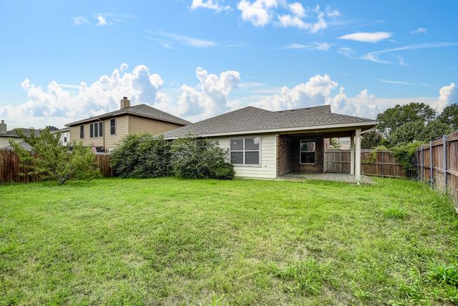Back of house featuring a patio, roof with shingles, and a fenced backyard | Image 17