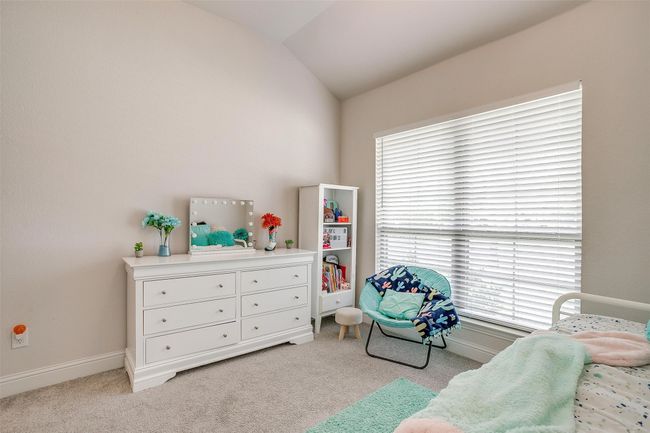 Carpeted bedroom with vaulted ceiling and baseboards | Image 33