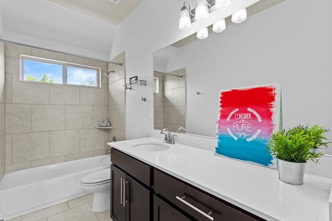 Bathroom featuring vanity, toilet, shower combination, and tile patterned flooring | Image 25