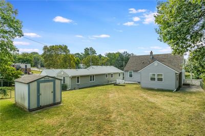 Rear view of property with a lawn and a storage unit | Image 2