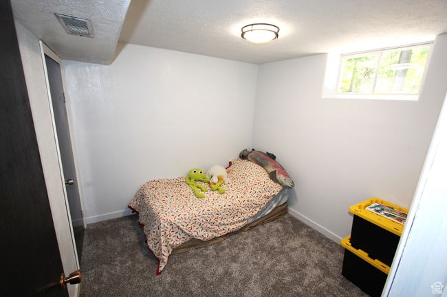 Carpeted bedroom with baseboards and a textured ceiling | Image 22