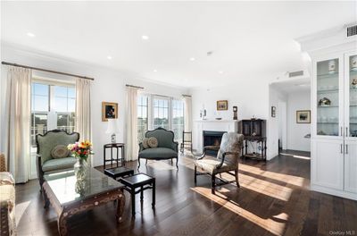 Living room with crown molding, a healthy amount of sunlight, and dark hardwood / wood-style flooring | Image 2