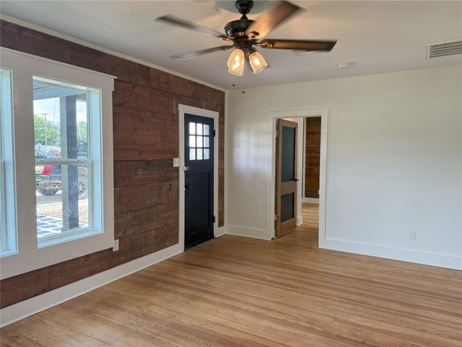 Foyer entrance with light wood-style flooring, a ceiling fan, and wooden walls | Image 29
