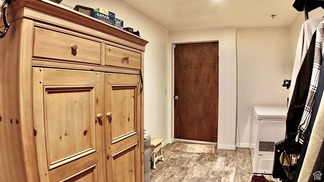 Interior space with baseboards, toilet, and wood finished floors | Image 75