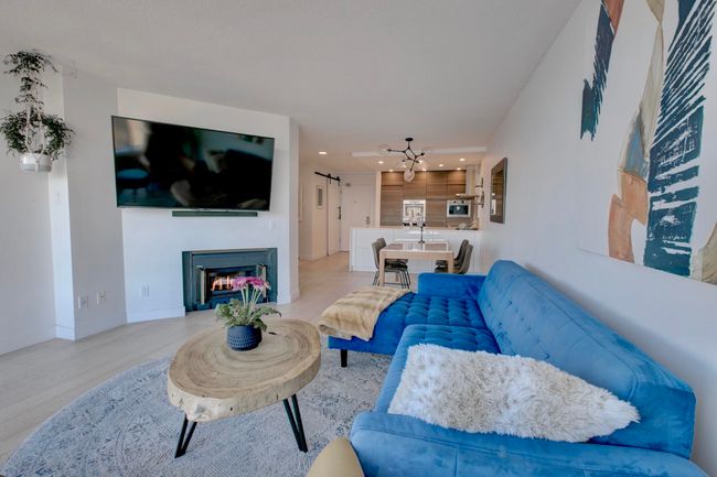 Living area featuring recessed lighting, light wood-type flooring, and a warm lit fireplace | Image 10