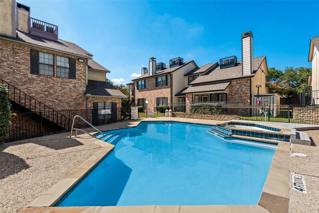 View of pool featuring a pool with connected hot tub and a residential view | Image 24