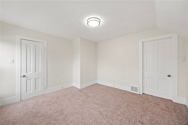 Empty room featuring carpet and lofted ceiling | Image 22