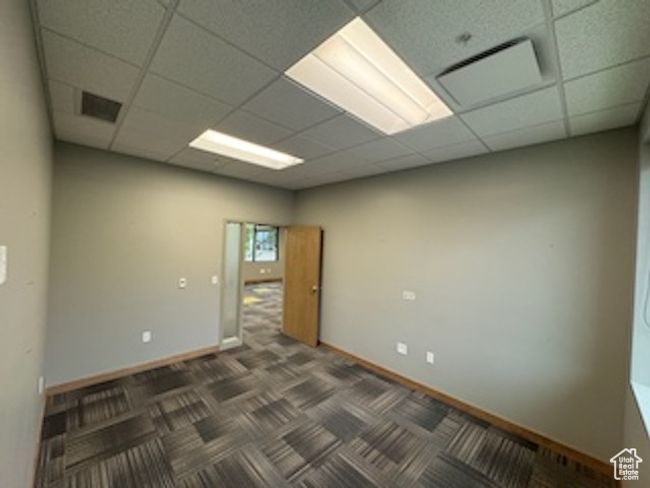 Unfurnished room featuring a drop ceiling and carpet floors | Image 15