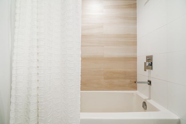 Bathroom featuring shower / tub combo | Image 26
