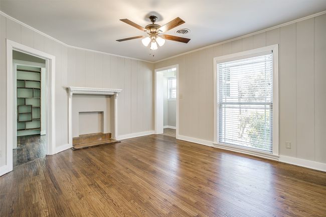 Unfurnished living room featuring ornamental molding, a ceiling fan, and wood finished floors | Image 5