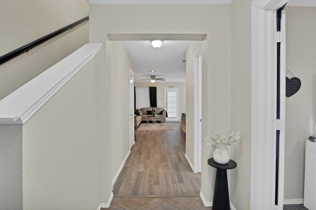 Hallway featuring tile patterned floors and baseboards | Image 5