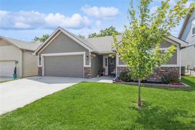 View of front of house featuring a large garage, beautiful front lawn and charming exterior | Image 2