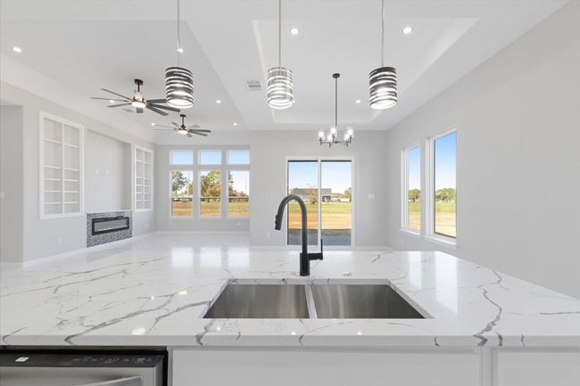 Kitchen with open floor plan, recessed lighting, a raised ceiling, plenty of natural light, and dishwashing machine | Image 14