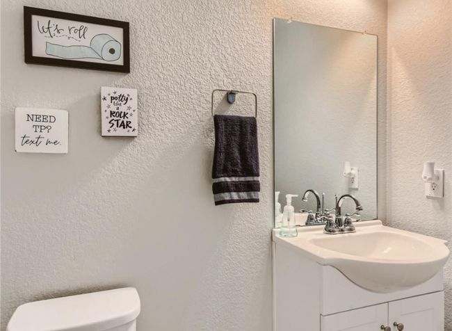 Bathroom with vanity and a textured wall | Image 10