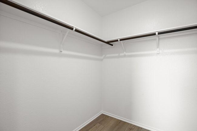 Walk in closet featuring wood finished floors | Image 18