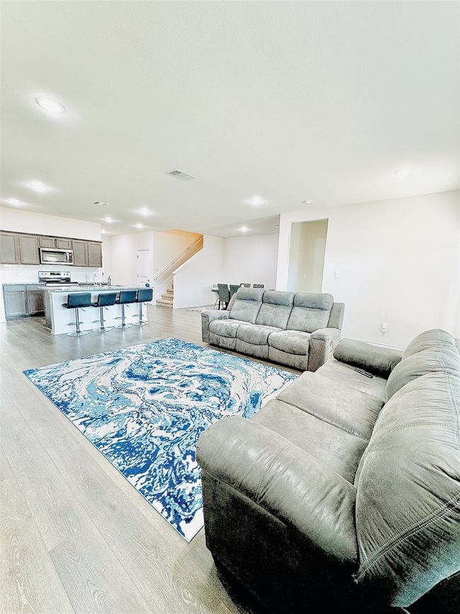 Living room featuring stairs, light wood-style floors, and recessed lighting | Image 11