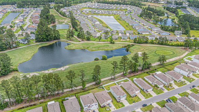 View of property location featuring nearby suburban area, a nearby body of water, and a local golf course | Image 32