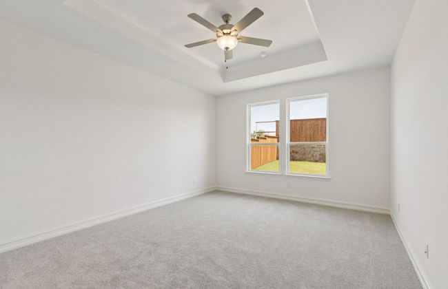 Spacious owner's suite highlighted by large windows and an exquisite tray ceiling *Real home pictured | Image 12
