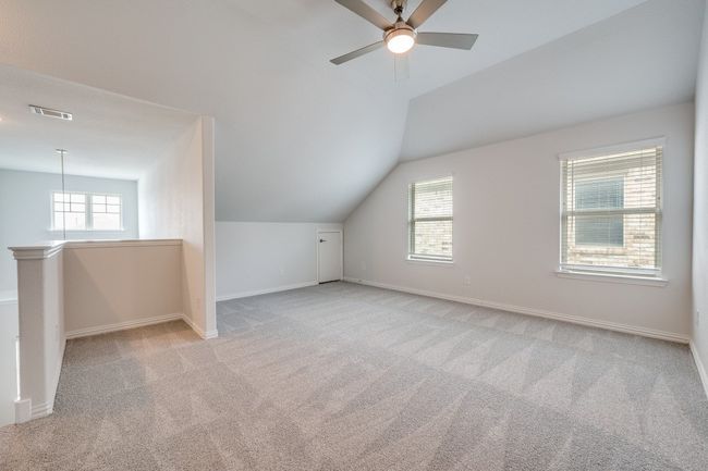 Additional living space with lofted ceiling, light carpet, and a ceiling fan | Image 8