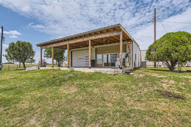 A 1, 200 sq ft workshop offers both utility and comfort, complete with heating and cooling, foam insulation, a commercial sink, and a full tiled bath, making it a dream space for work or play. | Image 24