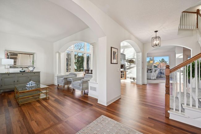 Entryway with living room to the left flowing into the dining room. | Image 6