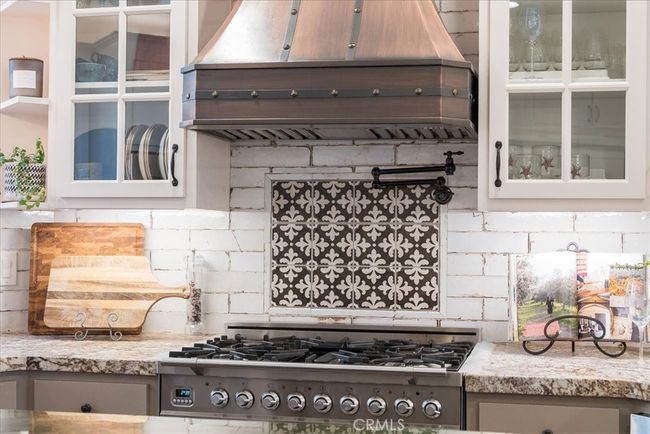 Beautiful custom tile work and range hood | Image 20