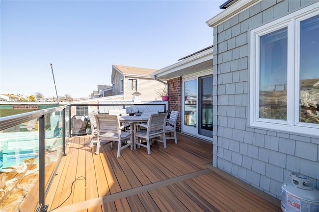 Wooden deck featuring outdoor dining space | Image 24