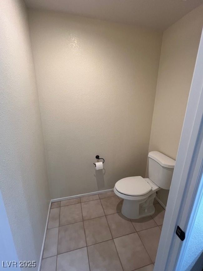 Unfurnished bedroom with a ceiling fan, visible vents, light tile patterned floors, baseboards, and a closet | Image 21