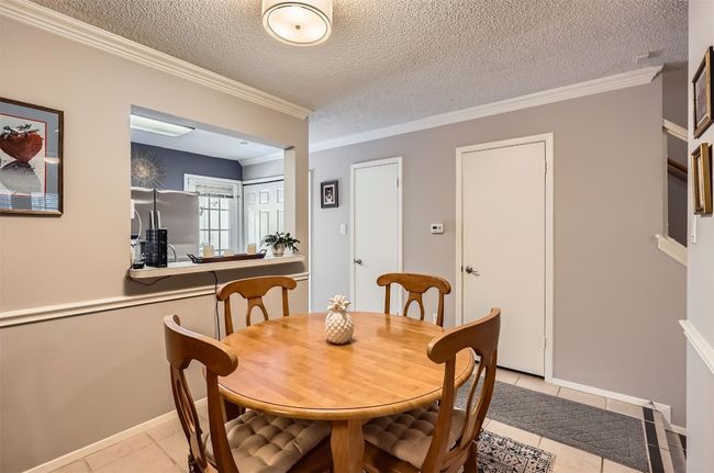 Dining area with door to storage under stairs. Left door to half bathroom. | Image 5