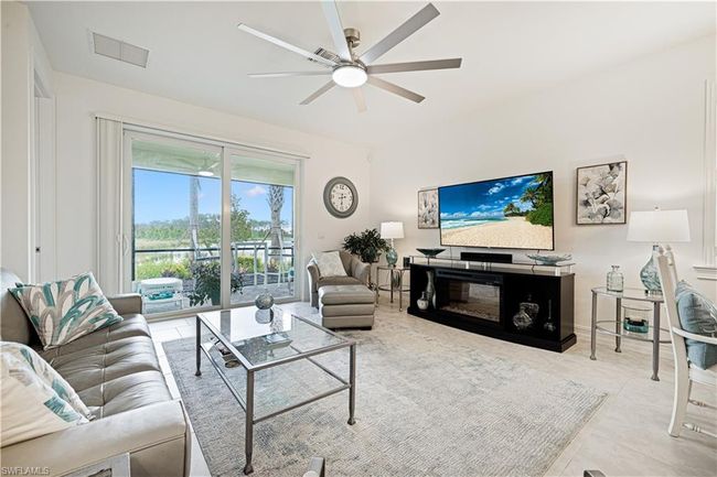 Living area featuring ceiling fan and tile patterned flooring | Image 7