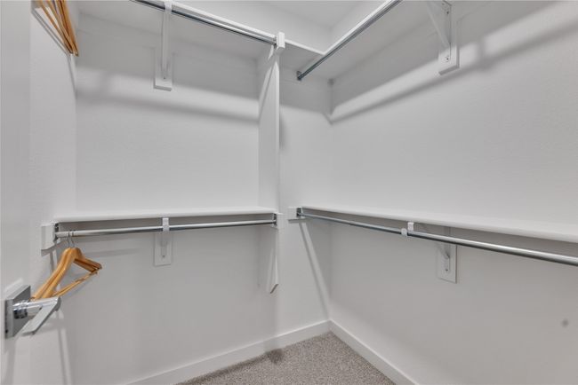 Spacious closet with light carpet | Image 22