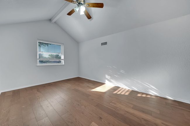 Spare room with ceiling fan and wood finished floors | Image 17
