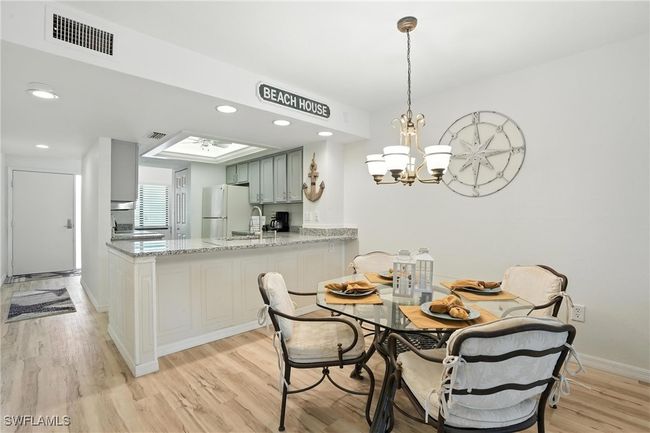 Dining space featuring light wood-type flooring, a chandelier, and recessed lighting | Image 12