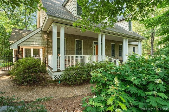 View of front of home featuring a shingled roof and covered porch | Image 6
