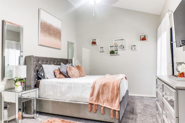 Bedroom featuring vaulted ceiling, baseboards, and carpet flooring | Image 8