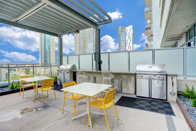 View of patio featuring outdoor dining area, a grill, a view of city, and area for grilling | Image 35