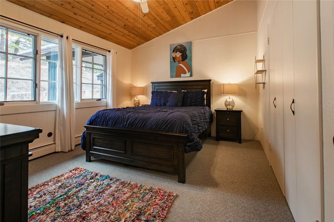 Bedroom featuring baseboard heating, wooden ceiling, carpet flooring, and vaulted ceiling | Image 8