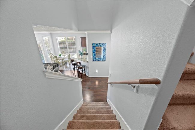 Carpeted stairs lead to the second floor, offering a cozy and comfortable transition between levels. | Image 25