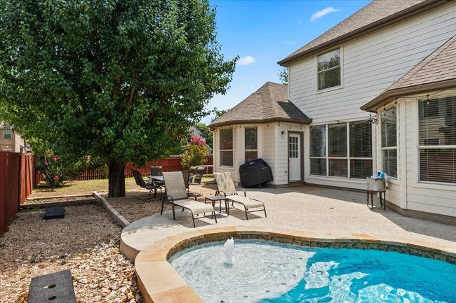 View of swimming pool with a fenced backyard, a patio area, and area for grilling | Image 24