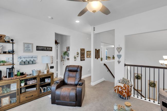 Living area with an upstairs landing, a ceiling fan, carpet floors, a chandelier, and recessed lighting | Image 24