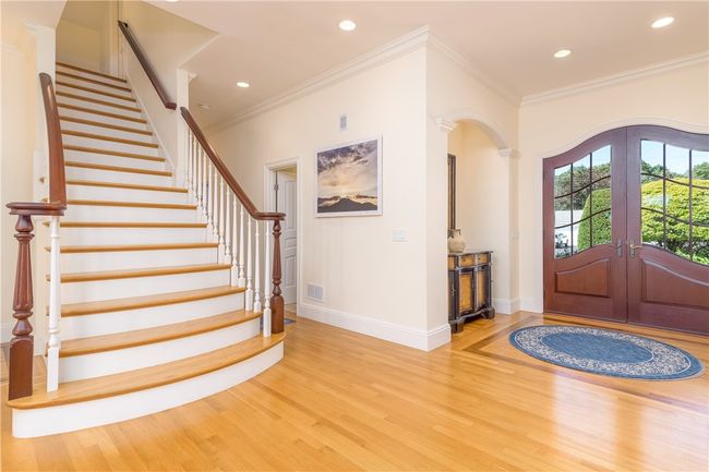 Lovely entry way showing the beautiful staircase. | Image 5