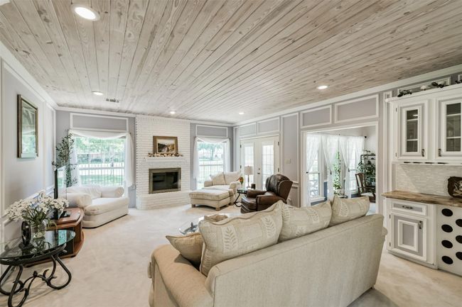 Custom Tongue-and-groove ceiling, extra molding, built-ins, soft color palette, along with terrific views of the golf course make this a wonderful family room! | Image 9