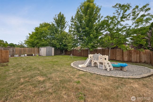 Fully fenced yard with storage shed | Image 24