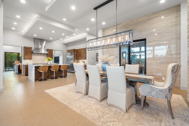 Dining room with an inviting chandelier and recessed lighting | Image 7
