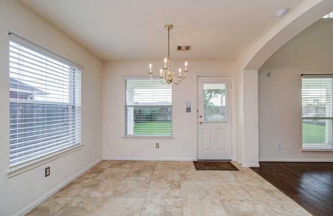 The breakfast area is located at the back of the home and enjoys views of the private backyard. | Image 13