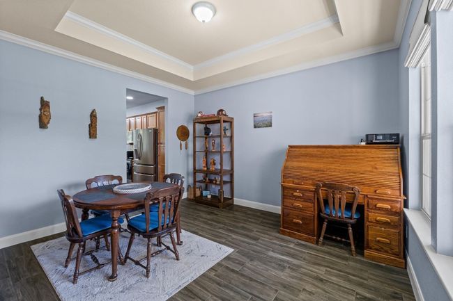 Dining space with a raised ceiling and crown molding | Image 19